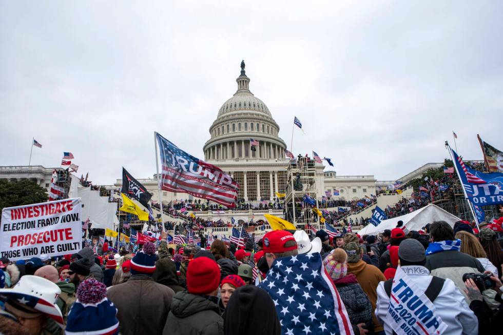 FILE - Rioters loyal to President Donald Trump gather on the West Front of the U.S. Capitol in ...