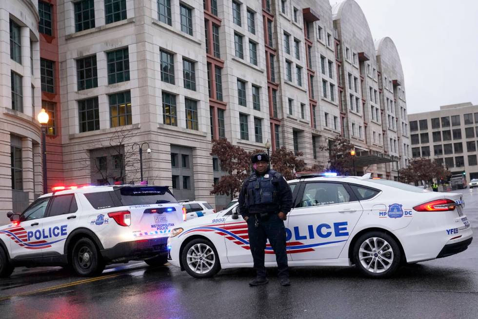 Police stand guard as they wait for former President Donald Trump to arrive at federal court ho ...