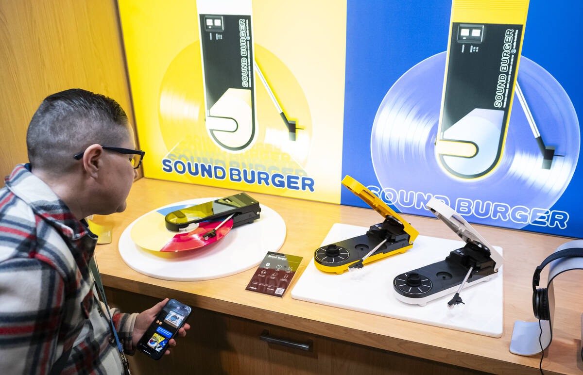 Amy Trombetta, of Texas, looks at the “Sound Burger” portable record players from ...
