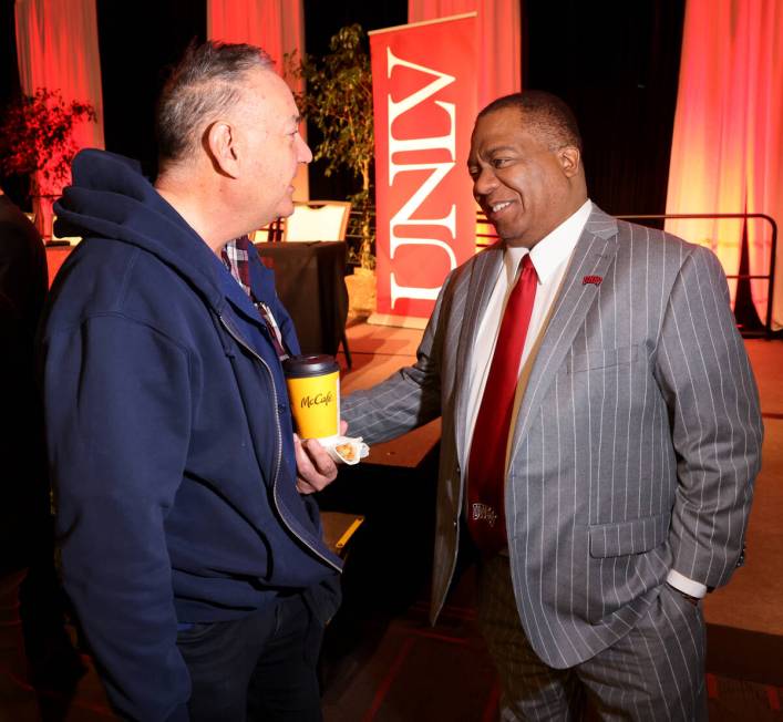 UNLV President Keith Whitfield, right, greets Associate Professor Richard Adams after an all ha ...