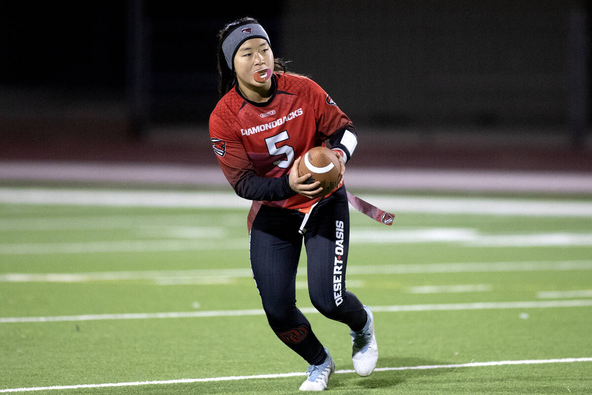 Desert Oasis quarterback Akemi Higa (5) looks to pass during a high school flag football game a ...