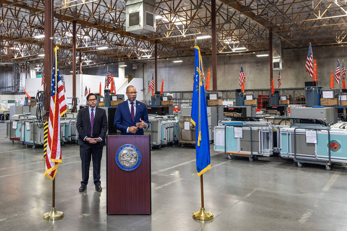 Nevada Attorney General Aaron Ford, right, speaks beside Secretary of State Francisco Aguilar a ...