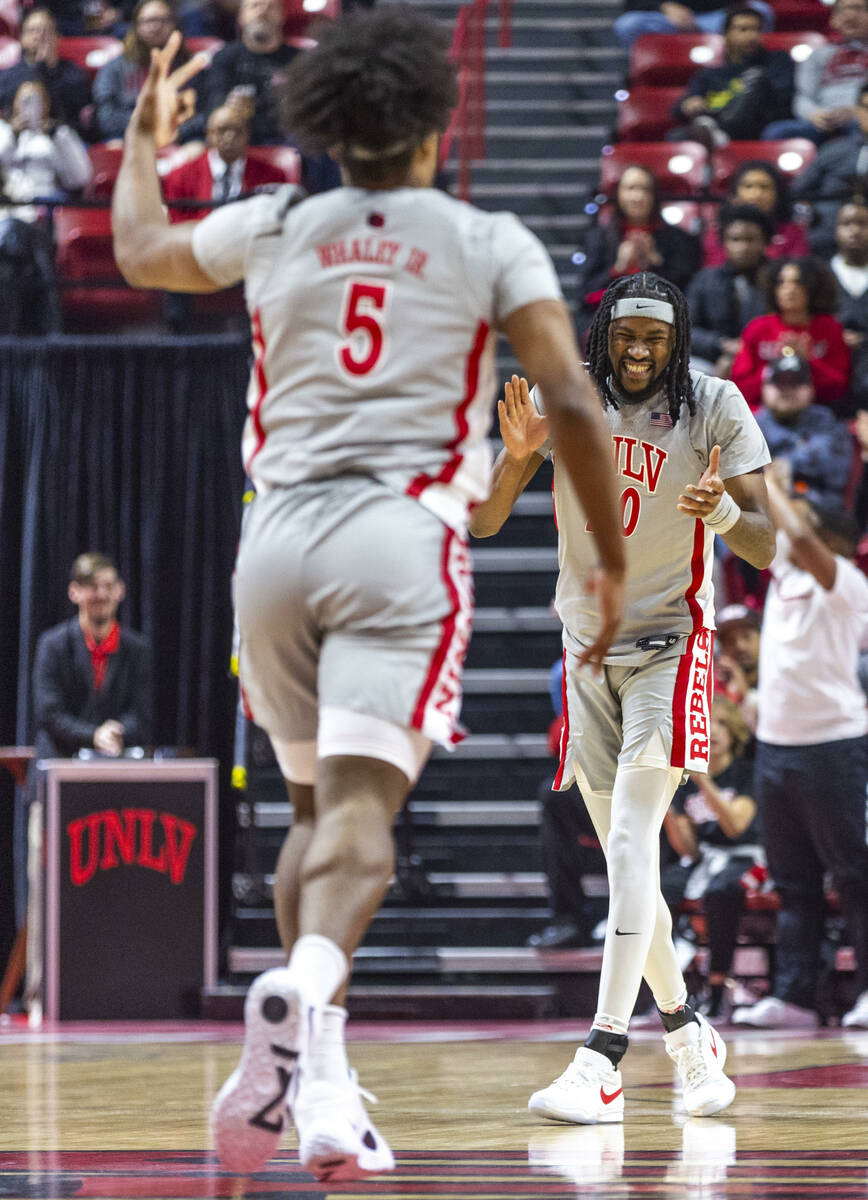 UNLV forward Keylan Boone (20) is pumped up after forward Rob Whaley Jr. (5) sinks a 3-point ba ...