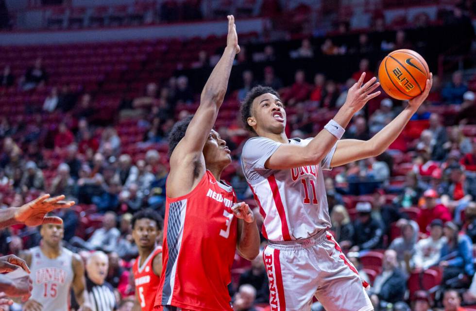 UNLV guard Dedan Thomas Jr. (11) gets inside of New Mexico Lobos guard Tru Washington (3) on a ...