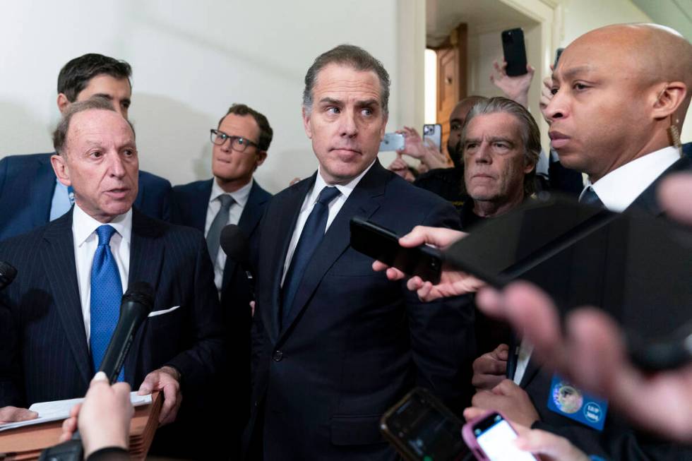 Hunter Biden, President Joe Biden's son, accompanied by his attorney Abbe Lowell, talks to repo ...