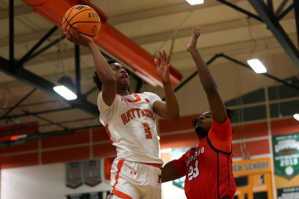 Mojave guard C.J. Shaw (3) shoots against Coronado guard Josiah Cunningham (23) during a high s ...