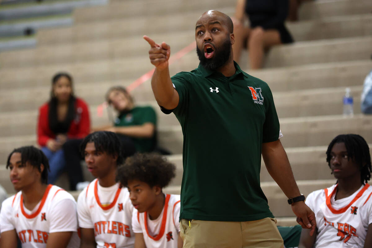 Mojave head coach KeJuan Clark shouts from the sidelines during a high school basketball game a ...