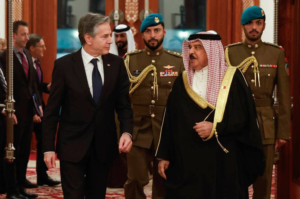 U.S. Secretary of State Antony Blinken, left, walks with Bahrain's King Hamad bin Isa al-Khalif ...