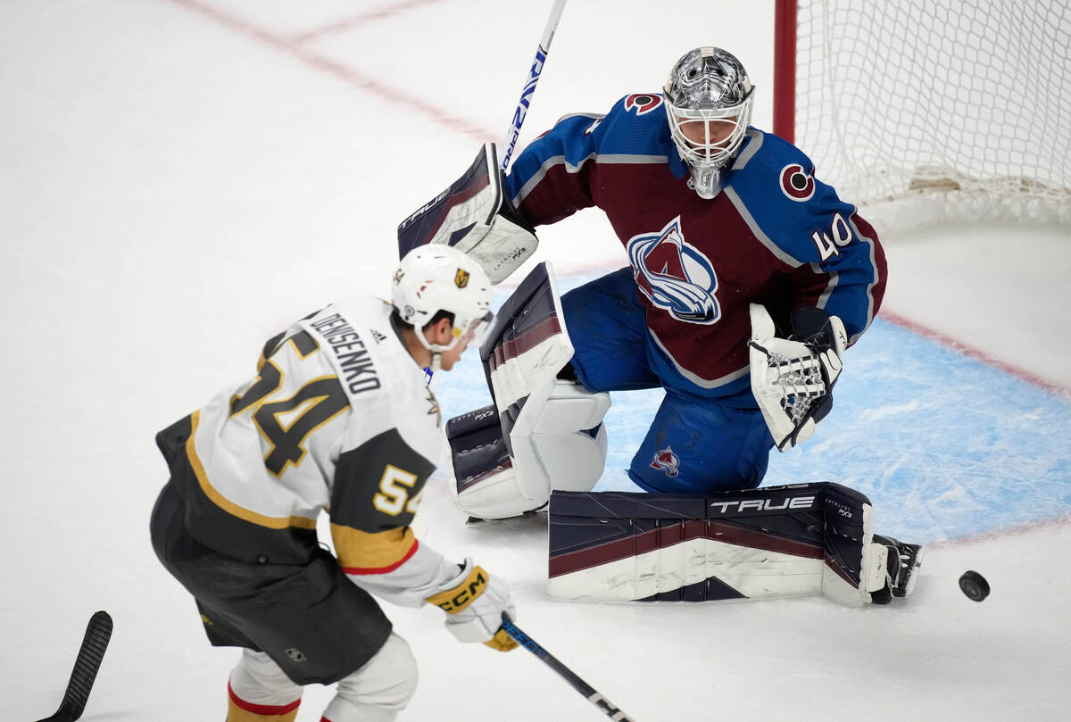 Colorado Avalanche goaltender Alexandar Georgiev, back, deflects a shot by Vegas Golden Knights ...