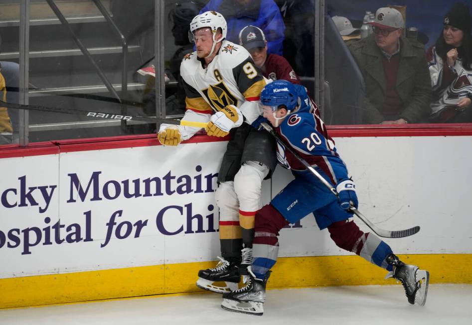 Colorado Avalanche center Ross Colton, front, checks Vegas Golden Knights center Jack Eichel du ...