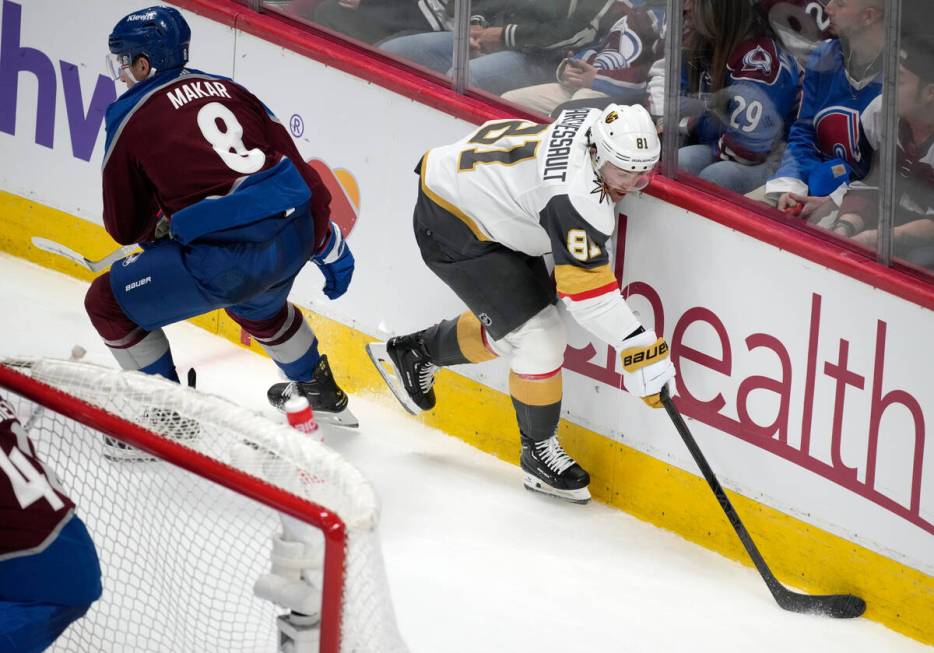 Vegas Golden Knights right wing Jonathan Marchessault, right, collects the puck next to Colorad ...