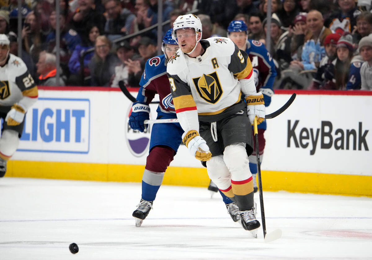 Vegas Golden Knights center Jack Eichel, front, pursues the puck with Colorado Avalanche left w ...