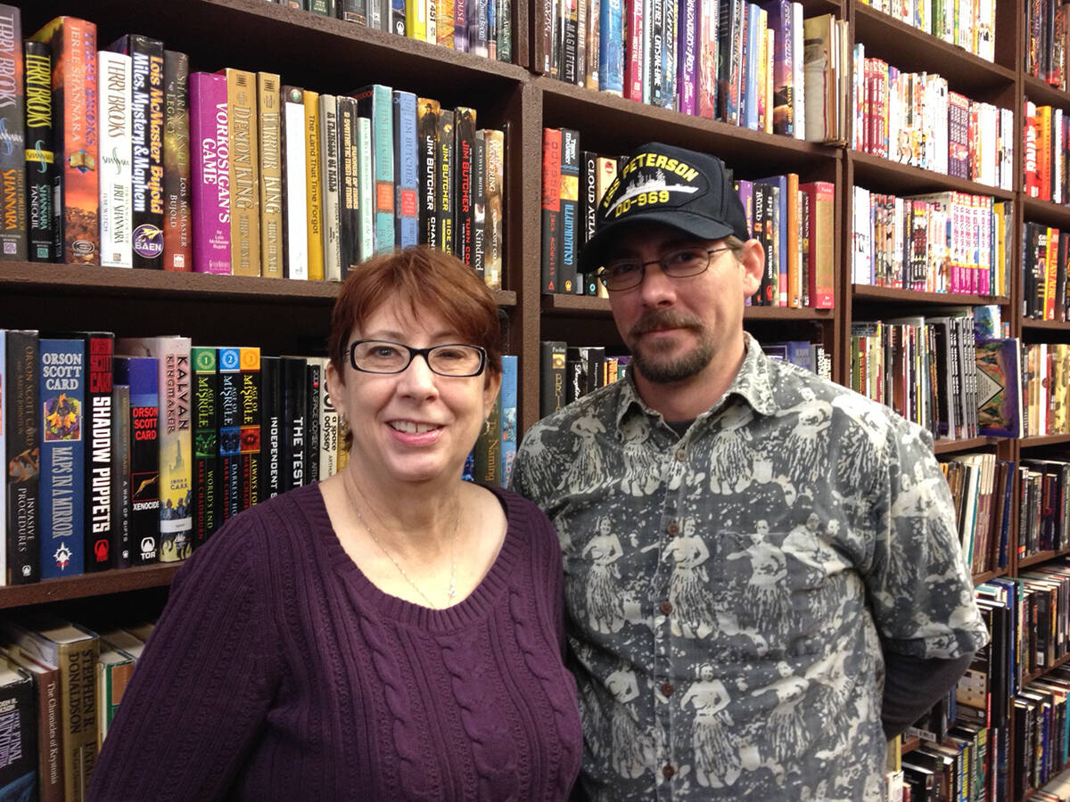 Dragon Castle Books owner Carla Spillman poses for a photo with her son, Danny Brown, at the bo ...