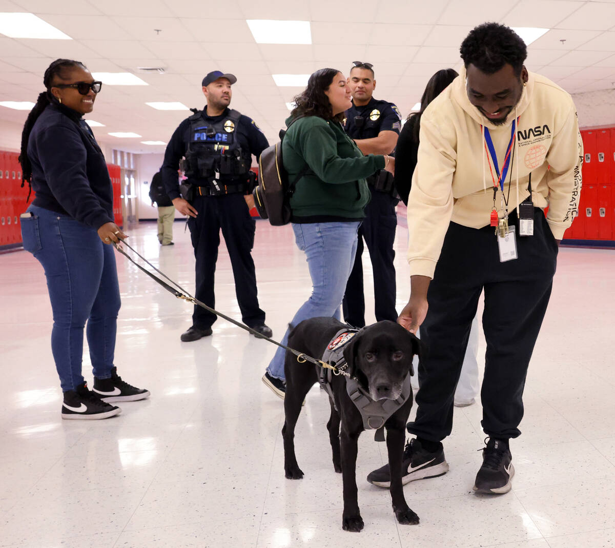 Therapy dog Eddie works Campus Security Monitor Maurice Caldwell at Valley High School in Las V ...