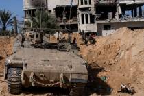 Israeli soldiers take up positions during a ground operation in Khan Younis, Gaza Strip on Wedn ...