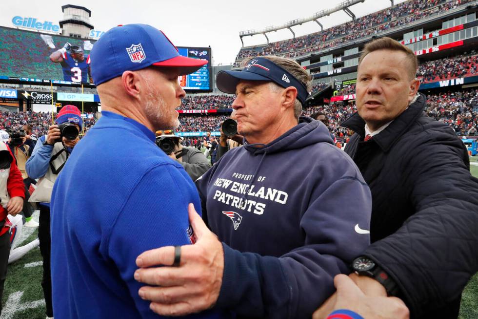 New England Patriots head coach Bill Belichick, right, embraces Buffalo Bills head coach Sean M ...