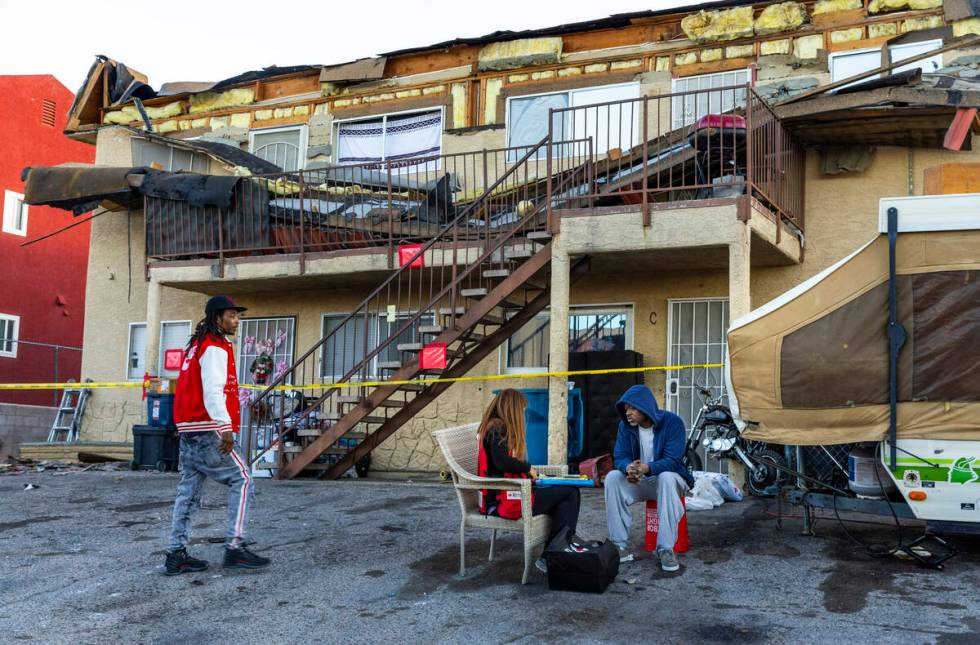 The Red Cross assists those displaced by an apartment building roof collapse near Carey Avenue ...