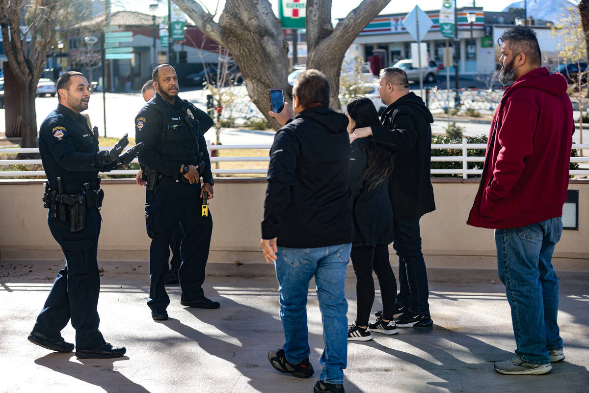 Family of the victims of a DUI crash interact with officers after the victim’s partner was ta ...