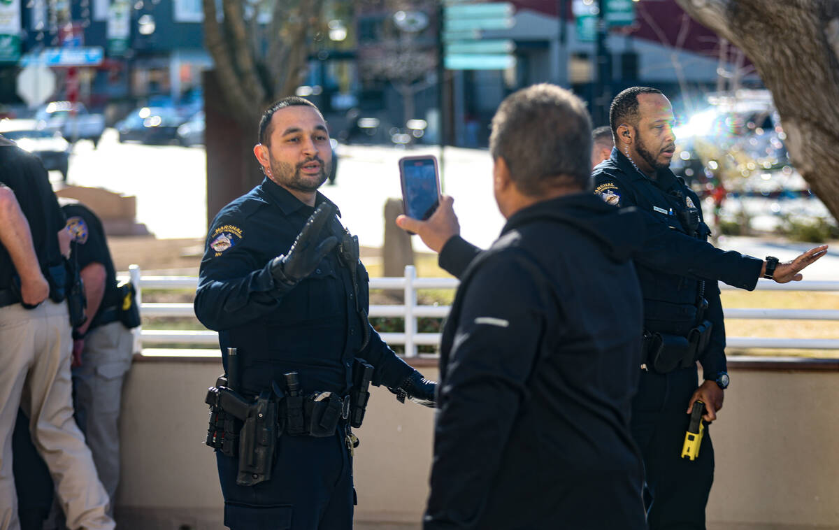 Family of the victims of a DUI crash interact with officers the victim’s partner was taken do ...