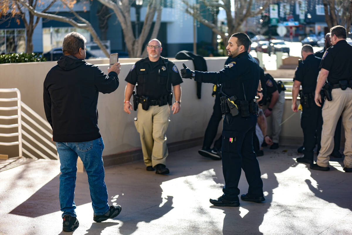 Family of the victims of a DUI crash interact with officers after the victim’s partner was ta ...