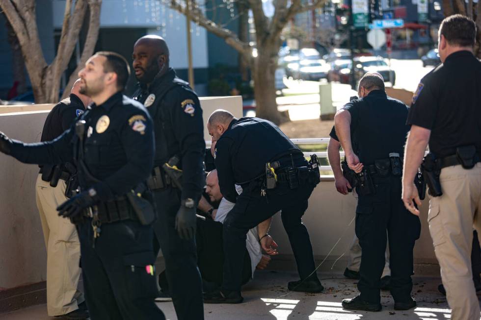 A family member of the victims of a DUI crash is held down by police following his dispute with ...