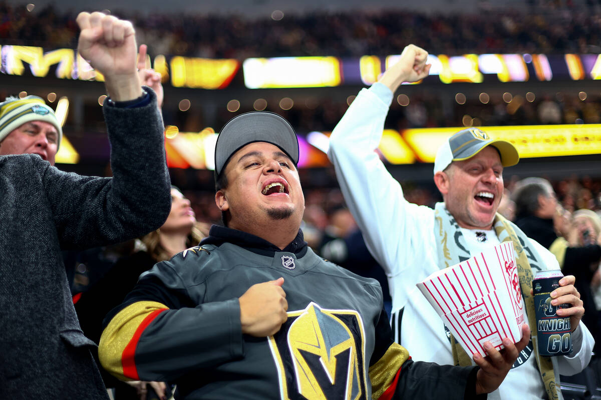 Golden Knights fan Gabriel Gonzalez, center, of Las Vegas, celebrates after the Knights scored ...