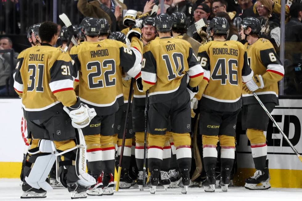 The Golden Knights celebrate their overtime win in an NHL hockey game against the Bruins at T-M ...