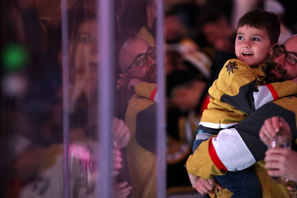 Golden Knights fans watch their team take the ice for an NHL hockey game against the Bruins at ...