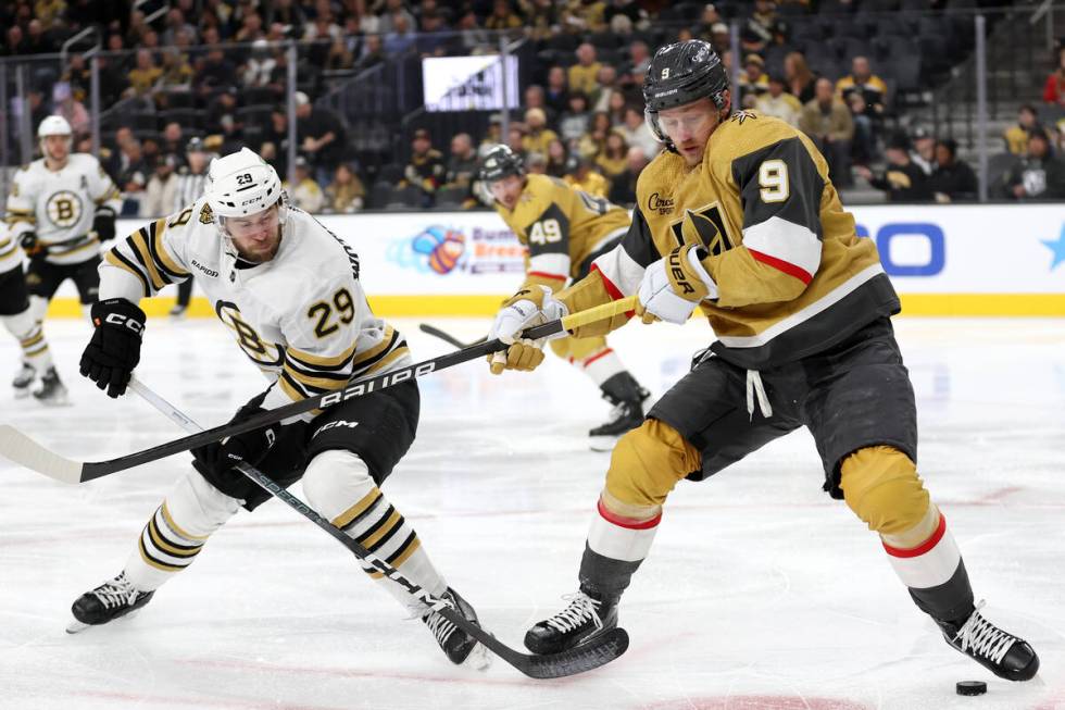 Bruins defenseman Parker Wotherspoon (29) and Golden Knights center Jack Eichel (9) battle for ...