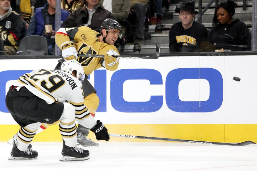 Golden Knights defenseman Alec Martinez (23) shoots while Bruins defenseman Parker Wotherspoon ...