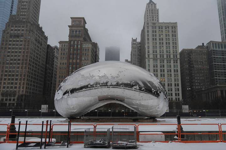 Snow covers the Cloud Gate sculpture in Millennium Park after a winter storm, Friday, Jan. 12, ...