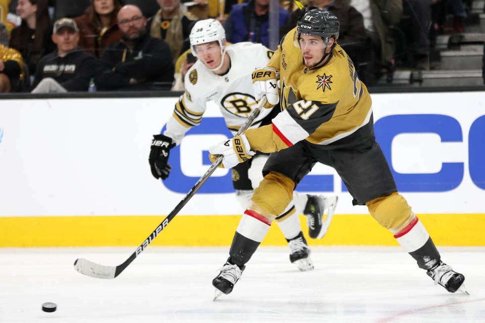 Golden Knights center Brett Howden (21) passes up the ice while Bruins center Morgan Geekie (39 ...