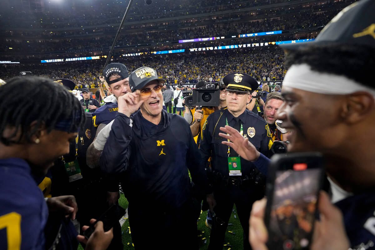 Michigan head coach Jim Harbaugh celebrates after their win against Washington in the national ...