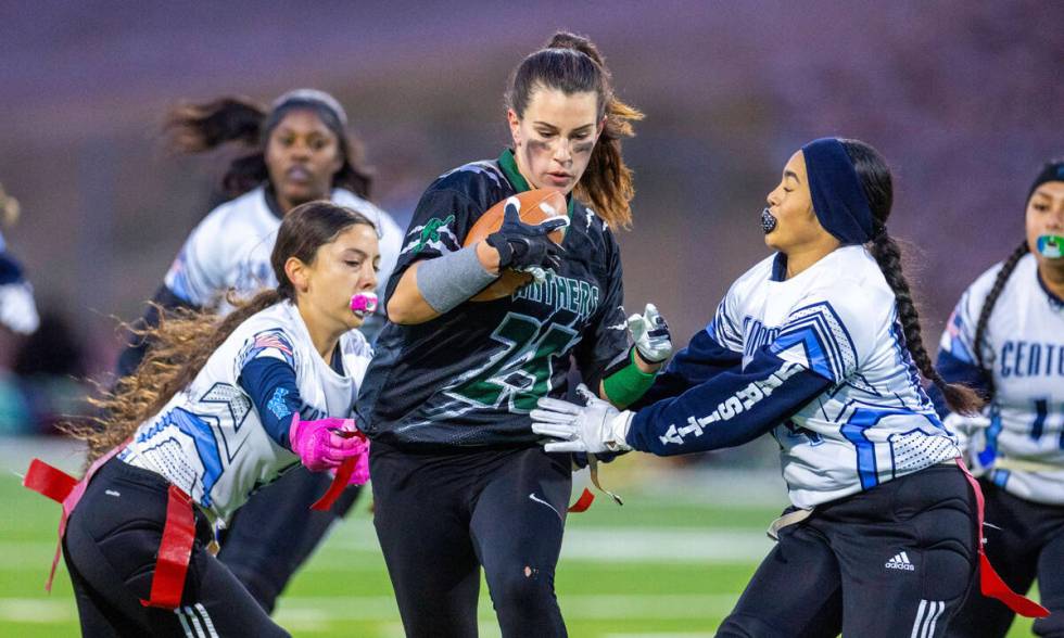 Palo Verde runner Olivia Perkins (25) has her jersey grabbed by Centennial defender Lyla Tuiaan ...