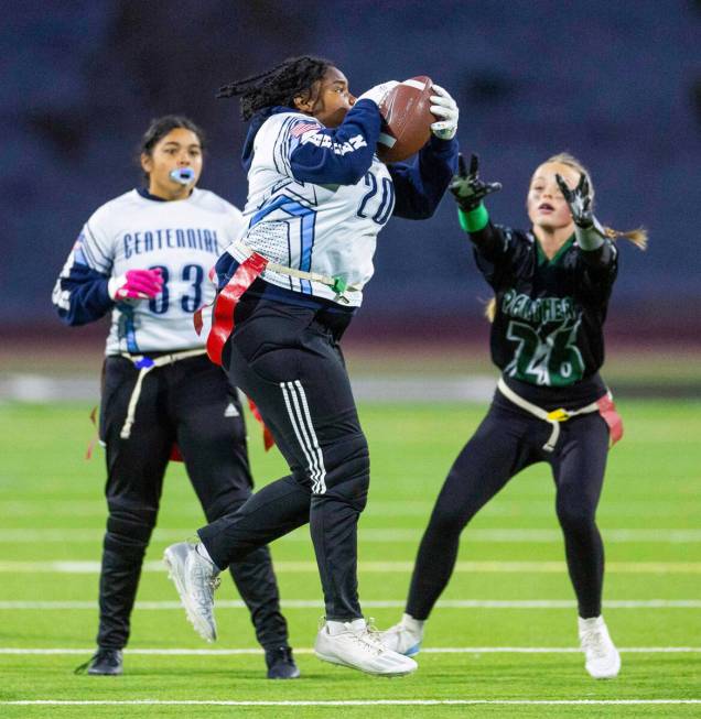 Centennial receiver Sah'Reniti Blazio (20) elevates for a catch against Palo Verde defender Sam ...