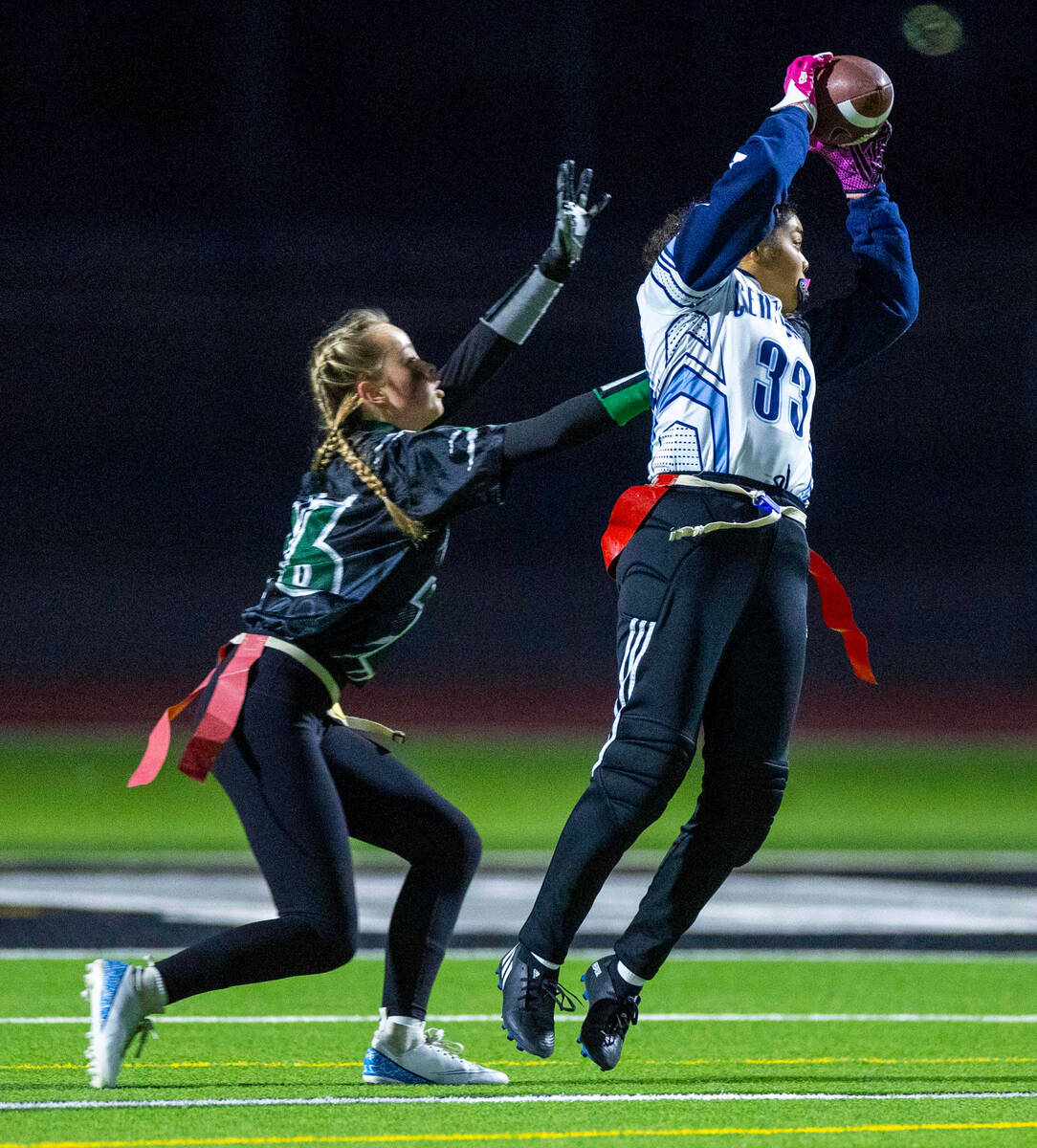 Centennial receiver Ana Cruz (33) leaps to score a touchdown over Palo Verde defender Samantha ...