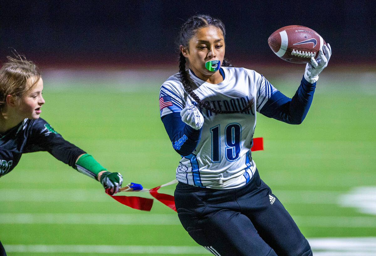 Centennial receiver Kairi Tabunar (19) scores a touchdown against a Palo Verde defender during ...