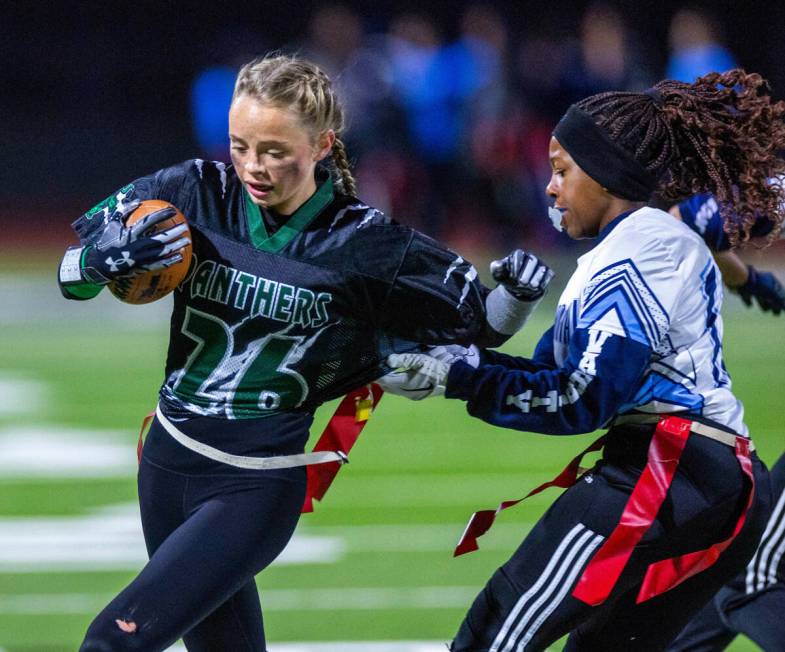 Palo Verde runner Samantha Manzo (26) has her flag pulled by Centennial defender Carissa McWill ...