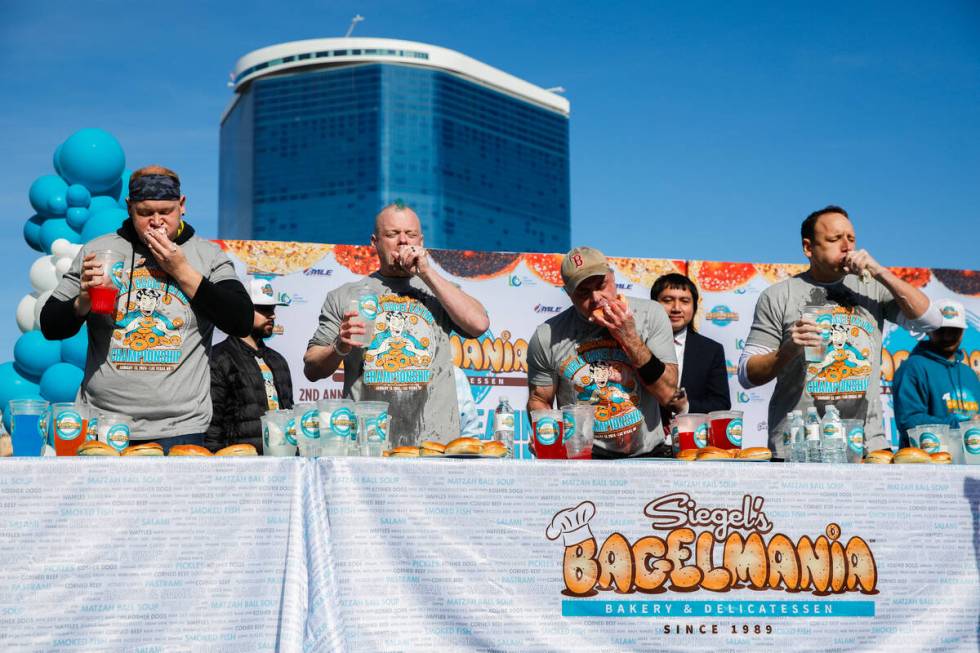 Derek Hendrickson, from left, Nick Wehry, Geoff Esper, and Joey Chestnut race to eat as many ba ...