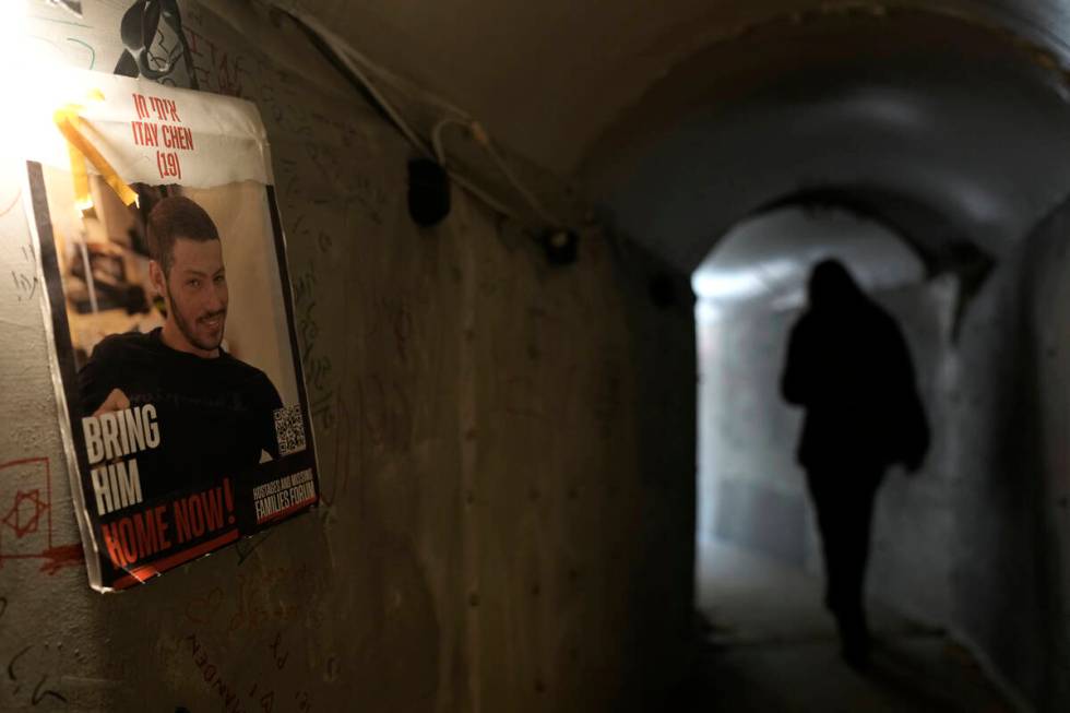 People walk through an installation simulating a tunnel in Gaza in an act of solidarity with ho ...