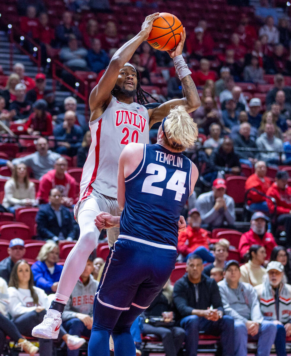 UNLV forward Keylan Boone (20) elevates over Utah State Aggies forward Karson Templin (24) for ...