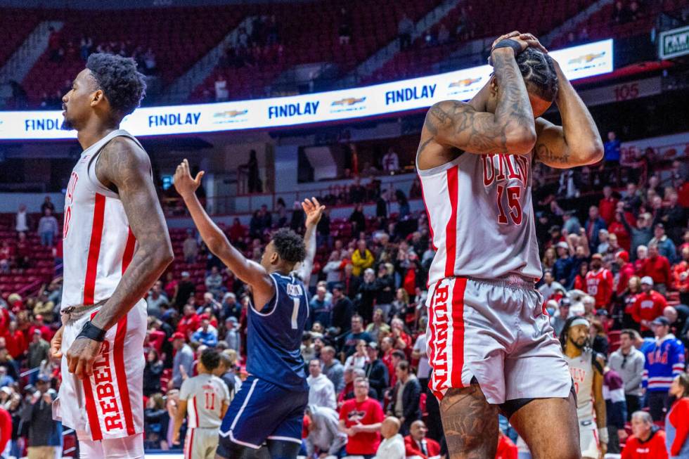 UNLV guard Luis Rodriguez (15) is dejected after a close loss as Utah State Aggies forward Grea ...