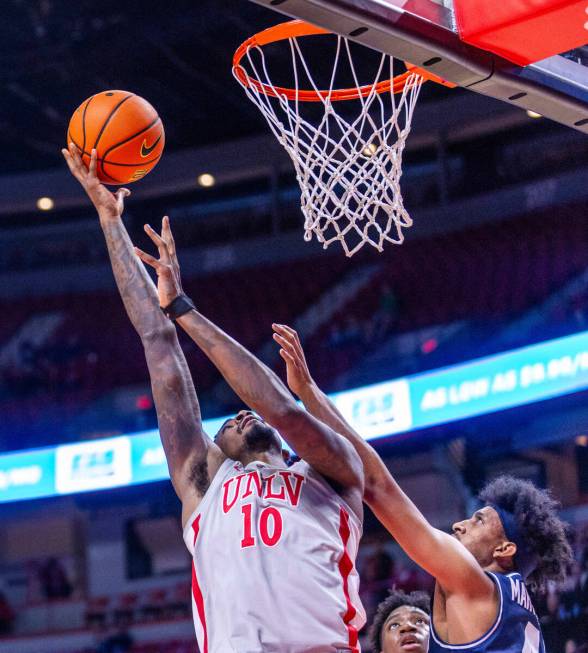 UNLV forward Kalib Boone (10) posts up for a basket over Utah State Aggies guard Ian Martinez ( ...