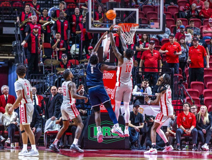 UNLV forward Kalib Boone (10) and Utah State Aggies forward Great Osobor (1) battle on the boar ...