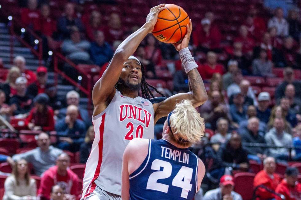 UNLV forward Keylan Boone (20) elevates over Utah State Aggies forward Karson Templin (24) for ...