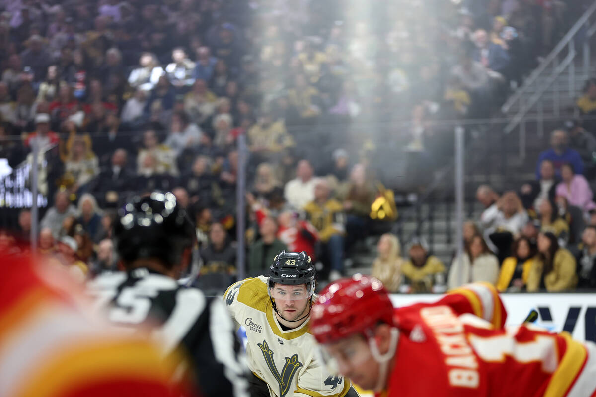 Golden Knights center Paul Cotter (43) watches a face off with the Flames during the first peri ...