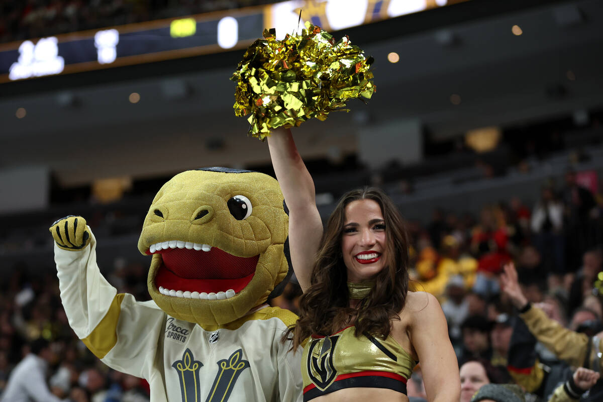 Chance the Gila monster and a Vegas Viva cheerleader pump up the crowd during the second period ...