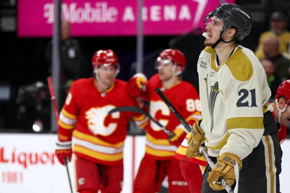 Golden Knights center Brett Howden (21) watches the replay of a Flames goal during the second p ...