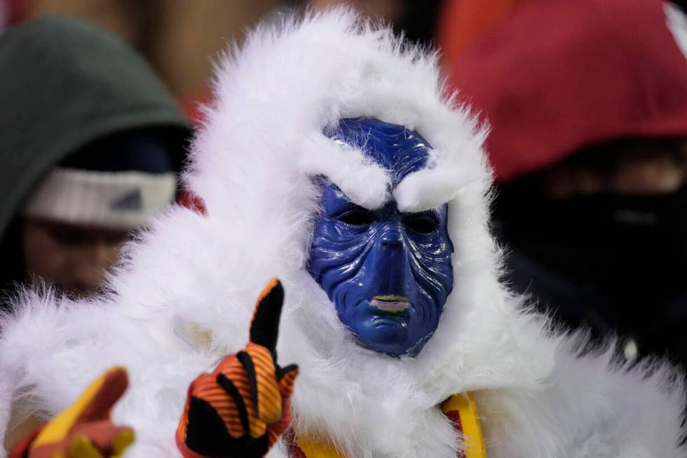 A fan in costume gestures before an NFL wild-card playoff football game between the Kansas City ...