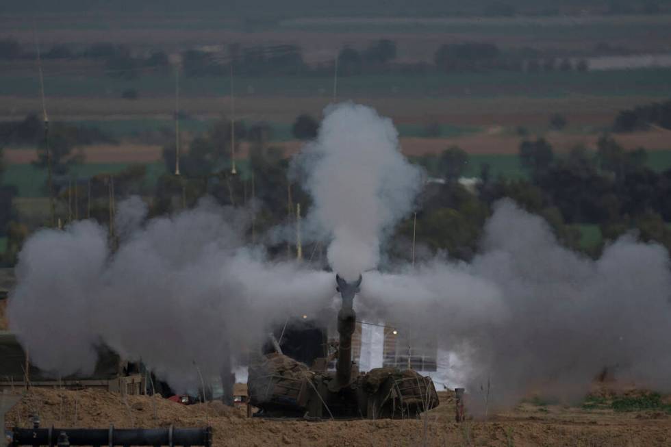 An Israeli mobile artillery unit fires a shell from southern Israel towards the Gaza Strip, in ...